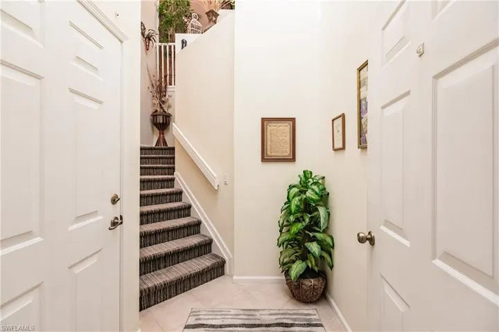 Stairs featuring tile patterned floors and baseboards
