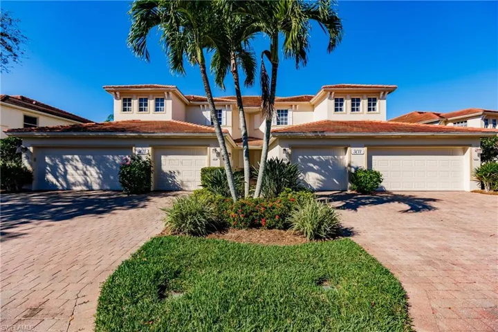 Mediterranean / spanish house featuring stucco siding, decorative driveway, and a tile roof