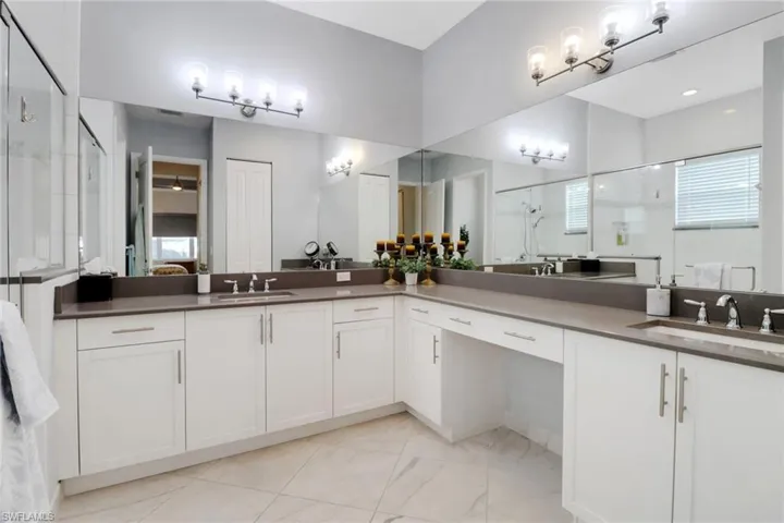 Bathroom featuring walk in shower and vanity