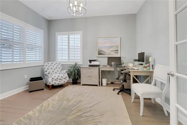 Office with  wood flooring