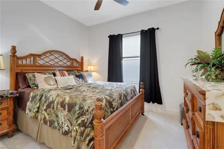 Carpeted bedroom with ceiling fan