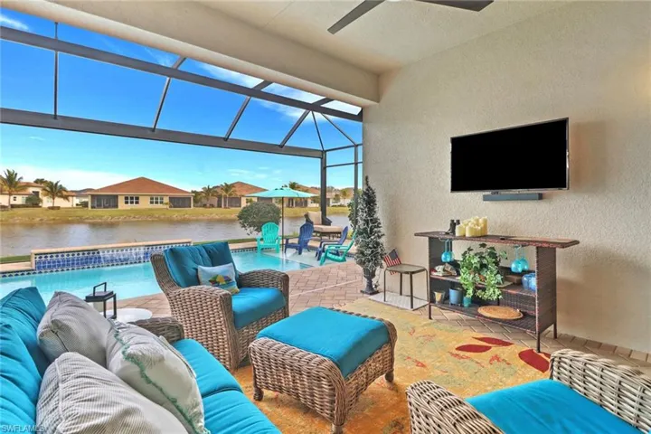 View of patio featuring ceiling fan, a lanai, and an outdoor hangout area