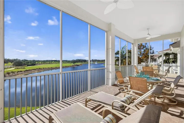 Sunroom / solarium with a water view, outdoor dining space, ceiling fan, and a balcony