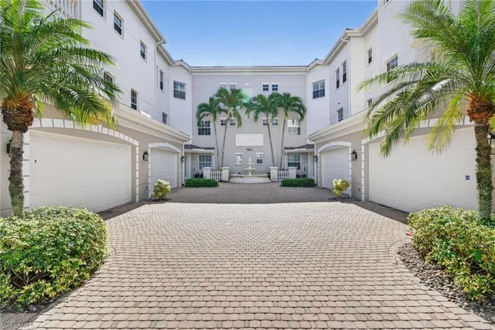 View of front facade featuring stucco siding and decorative driveway