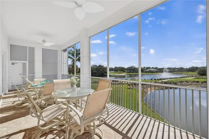 Sunroom featuring a water view