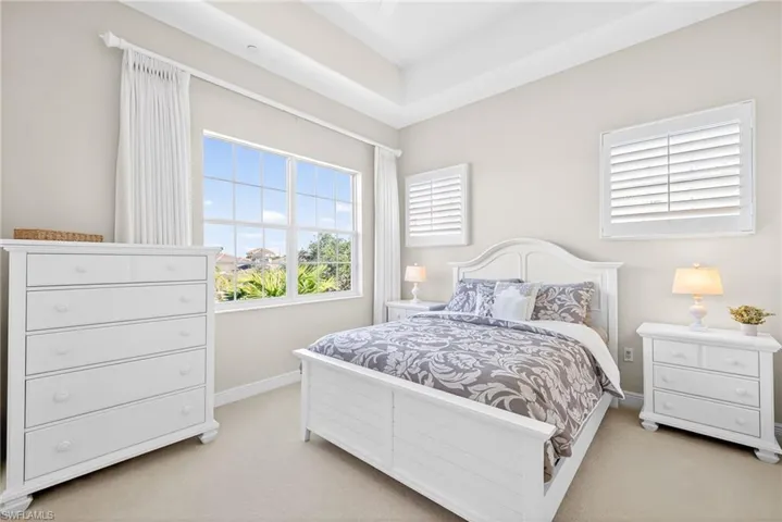 Carpeted bedroom featuring baseboards and a ceiling fan