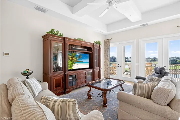 Living area featuring beam ceiling, french doors, a ceiling fan, and coffered ceiling