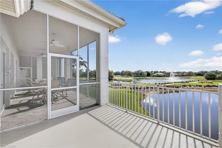 Balcony with a water view, a ceiling fan, and outdoor dining space