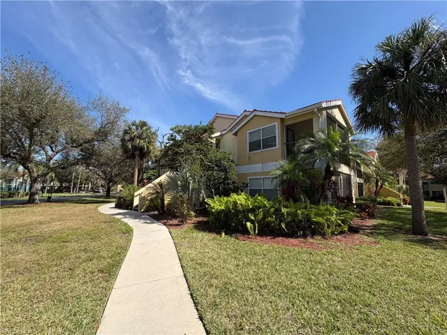 View of property exterior featuring a lawn and stucco siding