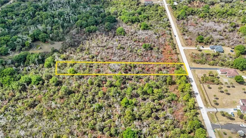 Aerial overview of property's location featuring property parcel outlined and a forest