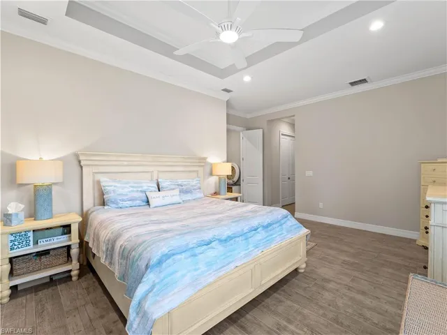 Bedroom featuring ornamental molding, light wood finished floors, ceiling fan, recessed lighting, and a closet