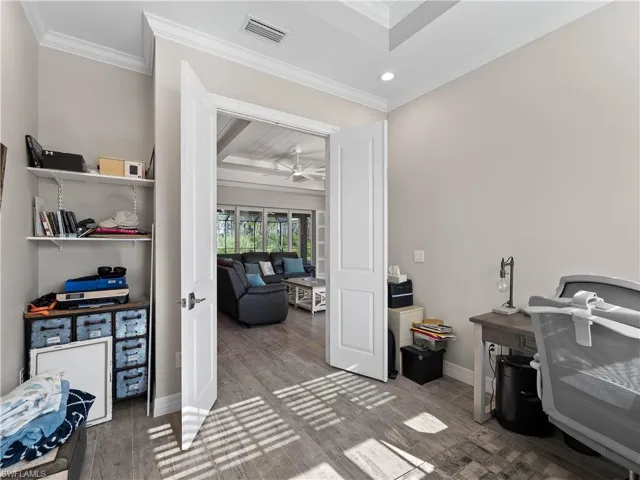 Home office with wood finished floors, recessed lighting, ornamental molding, french doors, and ceiling fan