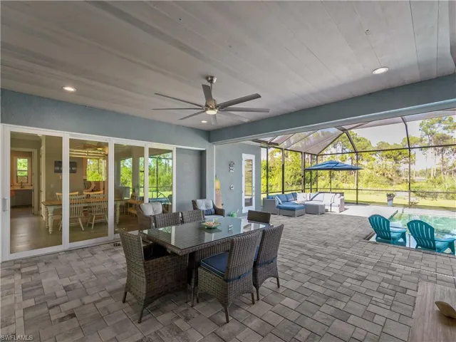 View of patio / terrace featuring outdoor lounge area, outdoor dining space, a lanai, a ceiling fan, and a sunroom