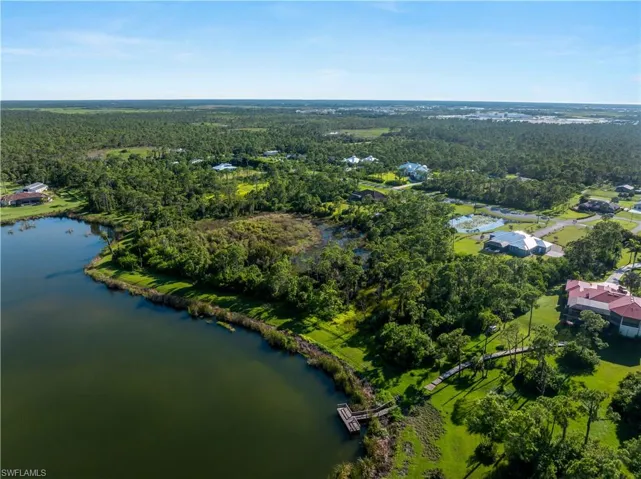 Aerial view of a heavily wooded area and a nearby body of water