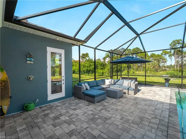 View of patio with a lanai, a sunroom, and an outdoor hangout area
