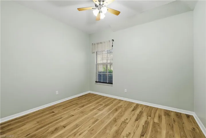 Spare room with light wood finished floors and ceiling fan