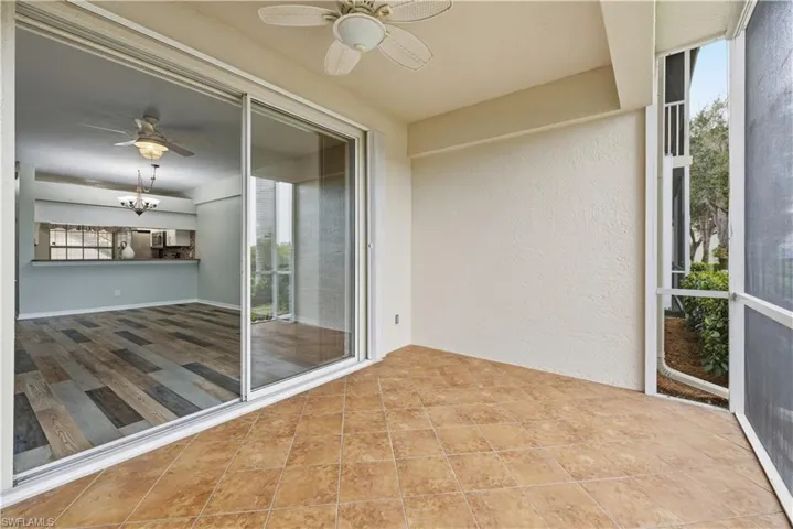Patio with ceiling fan overlooking the interior kitchen and living room