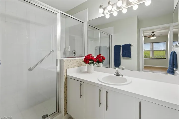 Full bath with a shower stall, vanity