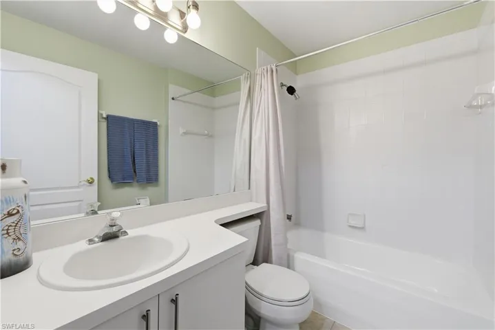Full bath with vanity and shower / bath combo with shower curtain