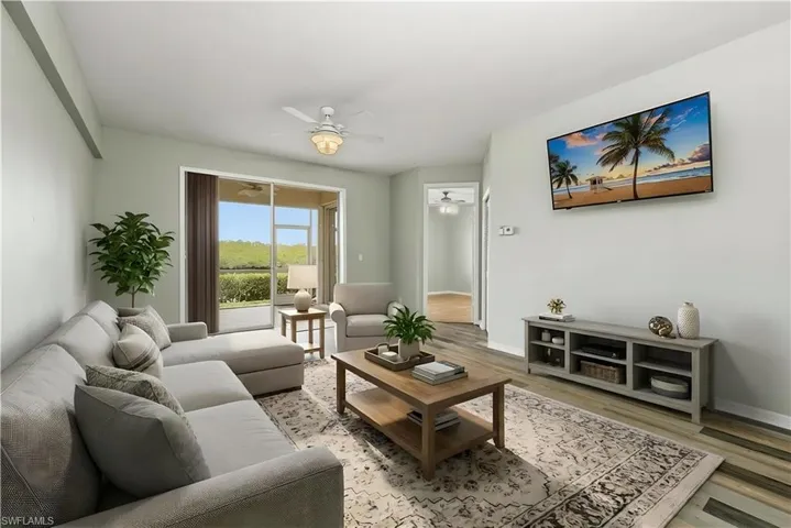 Staged Living room with ceiling fan and light wood-style finished floors