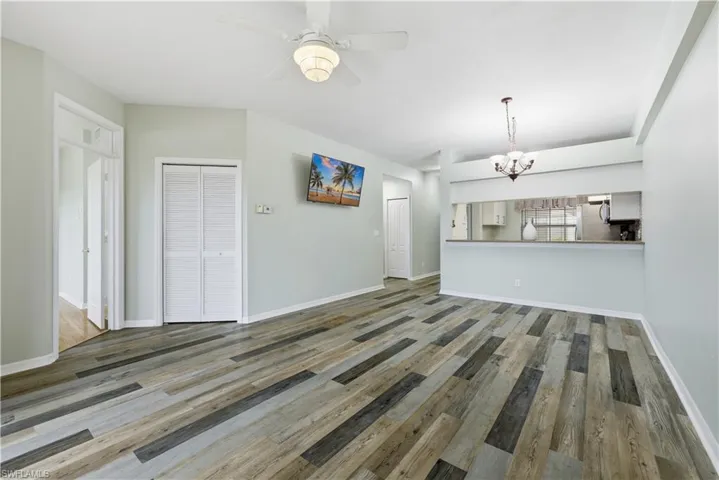 Unfurnished living room featuring a ceiling fan