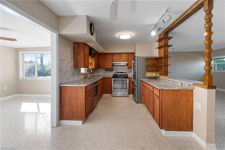 view from dining area into kitchen and sun room