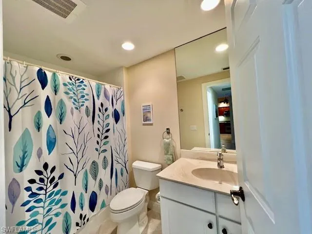 Bathroom featuring visible vents, recessed lighting, toilet, and vanity