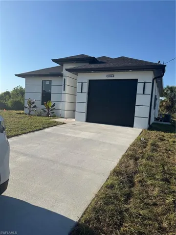 Prairie-style house featuring an attached garage and concrete driveway