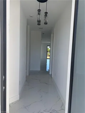 Hallway with a chandelier