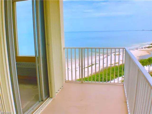 Balcony with a water view and a beach view