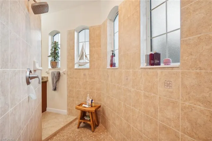 Full bathroom with a healthy amount of sunlight, tile patterned floors, and walk in shower