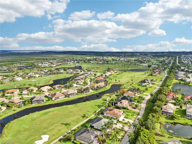 Birds eye view of property with a water view, view of golf course, and a residential view