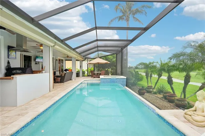 Pool featuring a lanai, ceiling fan, an in ground hot tub, and a patio area