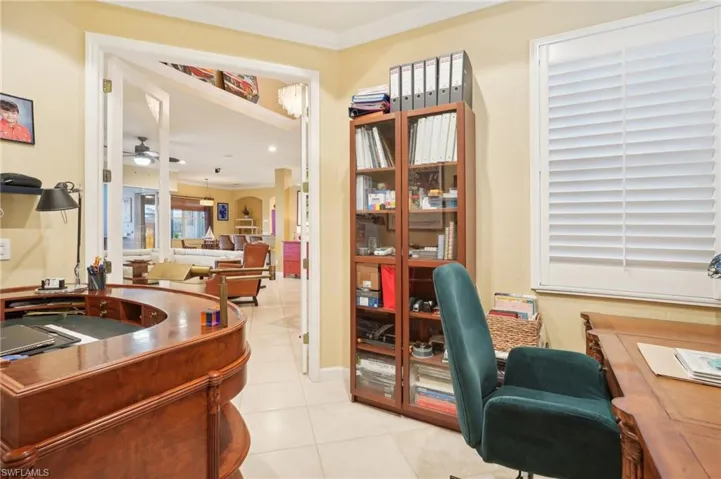 Home office featuring ceiling fan, ornamental molding, and light tile patterned floors