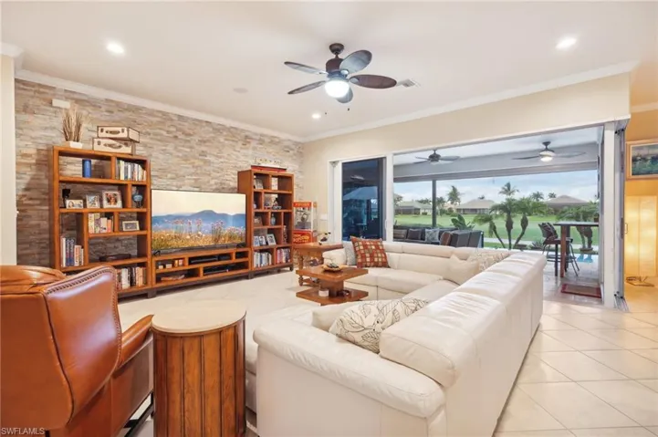 Living room featuring ornamental molding, light tile patterned floors, visible vents, ceiling fan, and recessed lighting