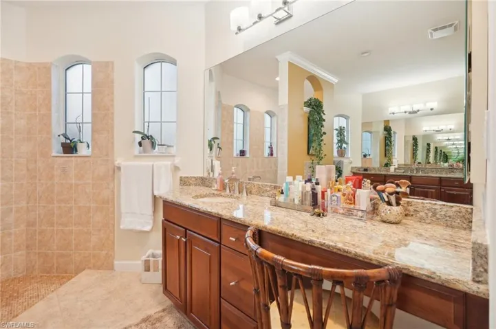 Full bathroom featuring vanity, visible vents, tile patterned floors, and walk in shower