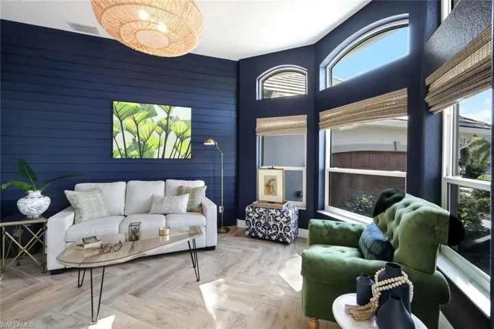 Living area featuring wooden walls and visible vents