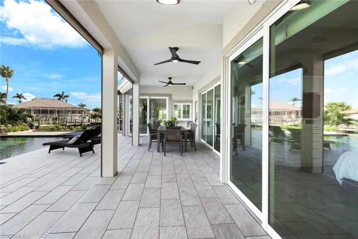 View of patio / terrace with outdoor dining space, a ceiling fan, and a water view