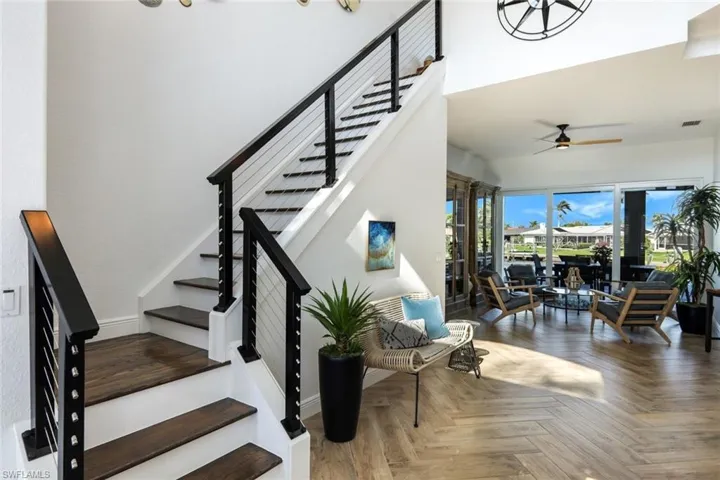 Staircase with visible vents and a ceiling fan