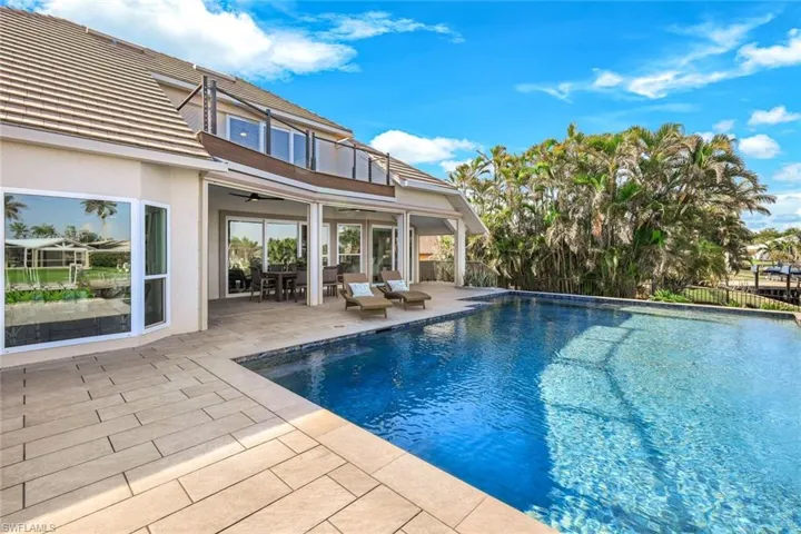 View of pool with fence, a fenced in pool, a patio, and a ceiling fan