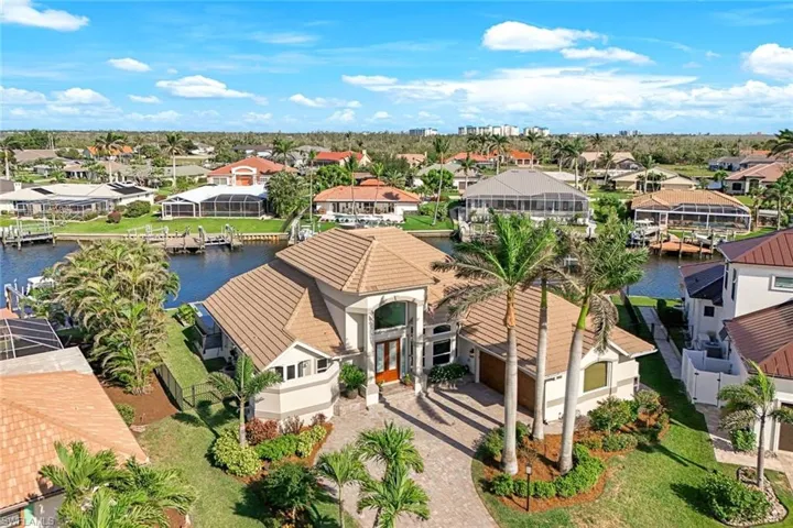Birds eye view of property featuring a water view and a residential view
