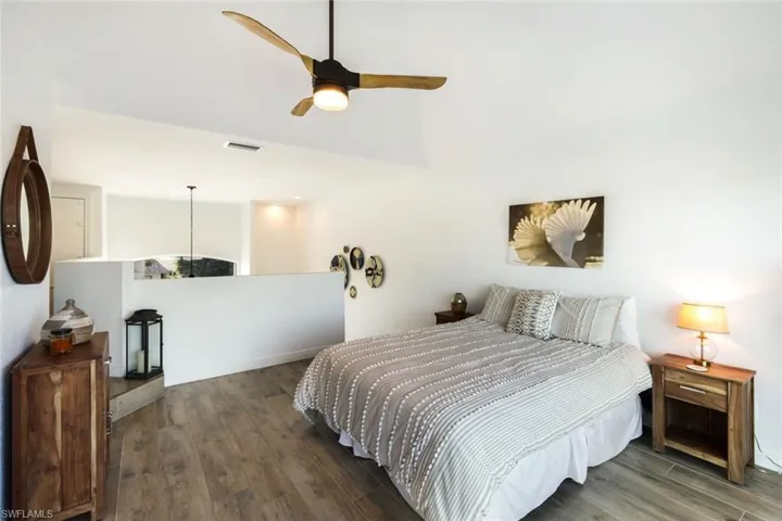 Bedroom with visible vents, ceiling fan, and wood finished floors