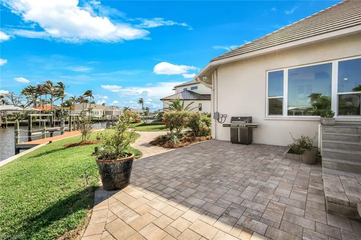 View of patio / terrace featuring a water view, a boat dock, and grilling area