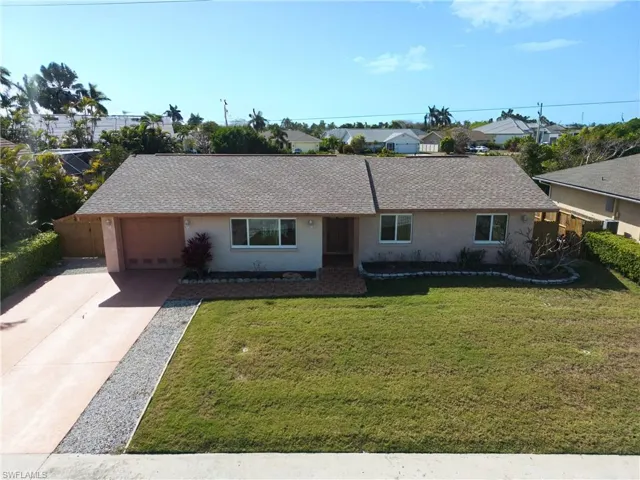 Ranch-style home featuring concrete driveway, stucco siding, a shingled roof, and an attached garage