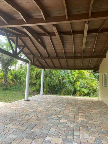 View of front of property featuring driveway, an attached garage, and stucco siding