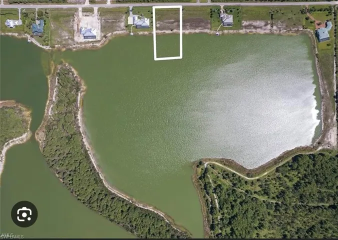 Aerial overview of property's location with a large body of water