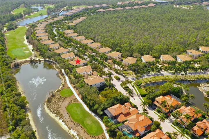 Aerial view of property's location with a nearby body of water and nearby suburban area