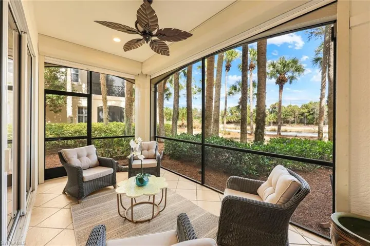 Sunroom / solarium with a ceiling fan and an outdoor hangout area