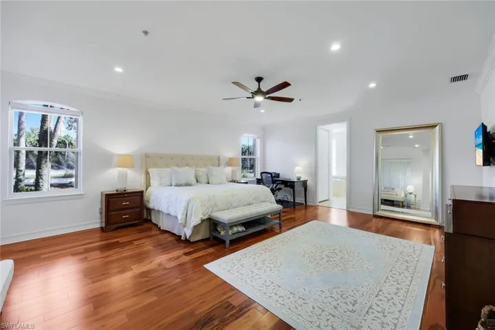Bedroom with ornamental molding, dark wood-type flooring, a desk, recessed lighting, and ceiling fan