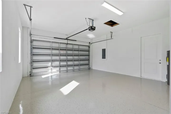 Garage with a garage door opener and electric panel